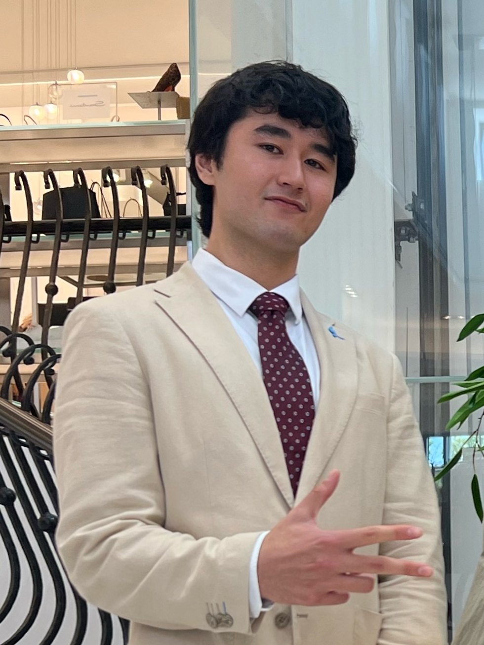 Alan, founder of ALYM Studio, in a linen blazer and tie